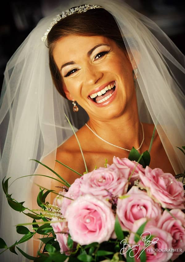 bride smiling with flowers